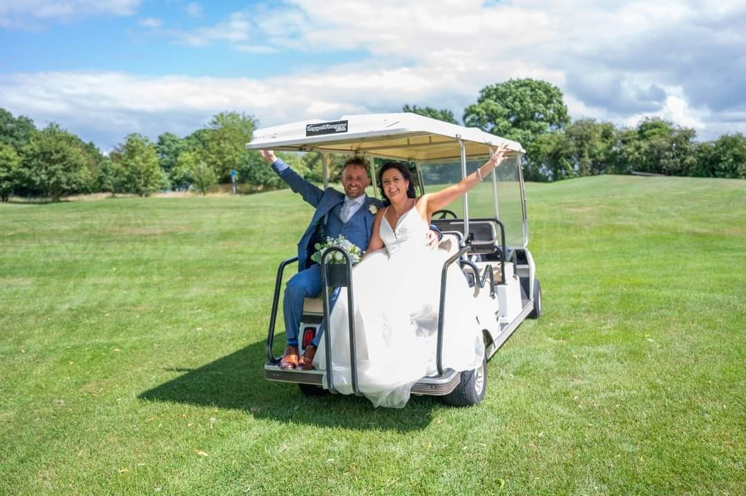 just married couple in a golf buggy