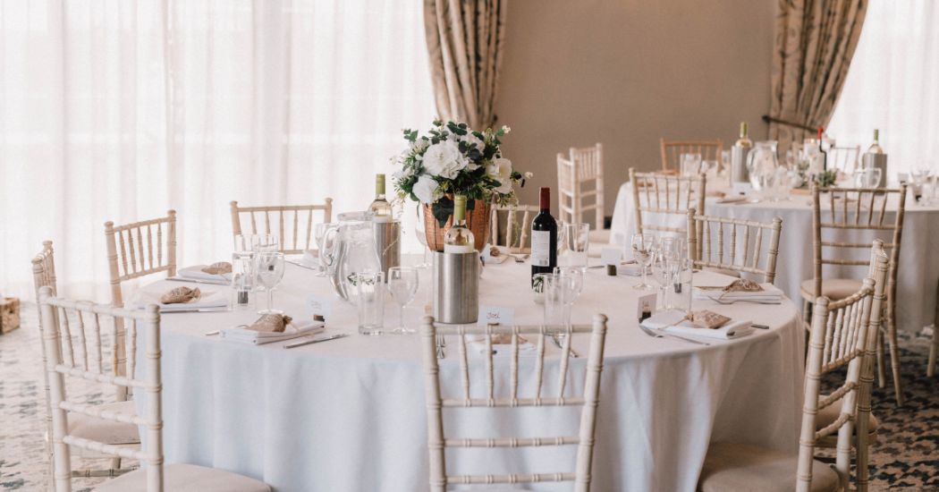 White chivari chairs in a wedding setting