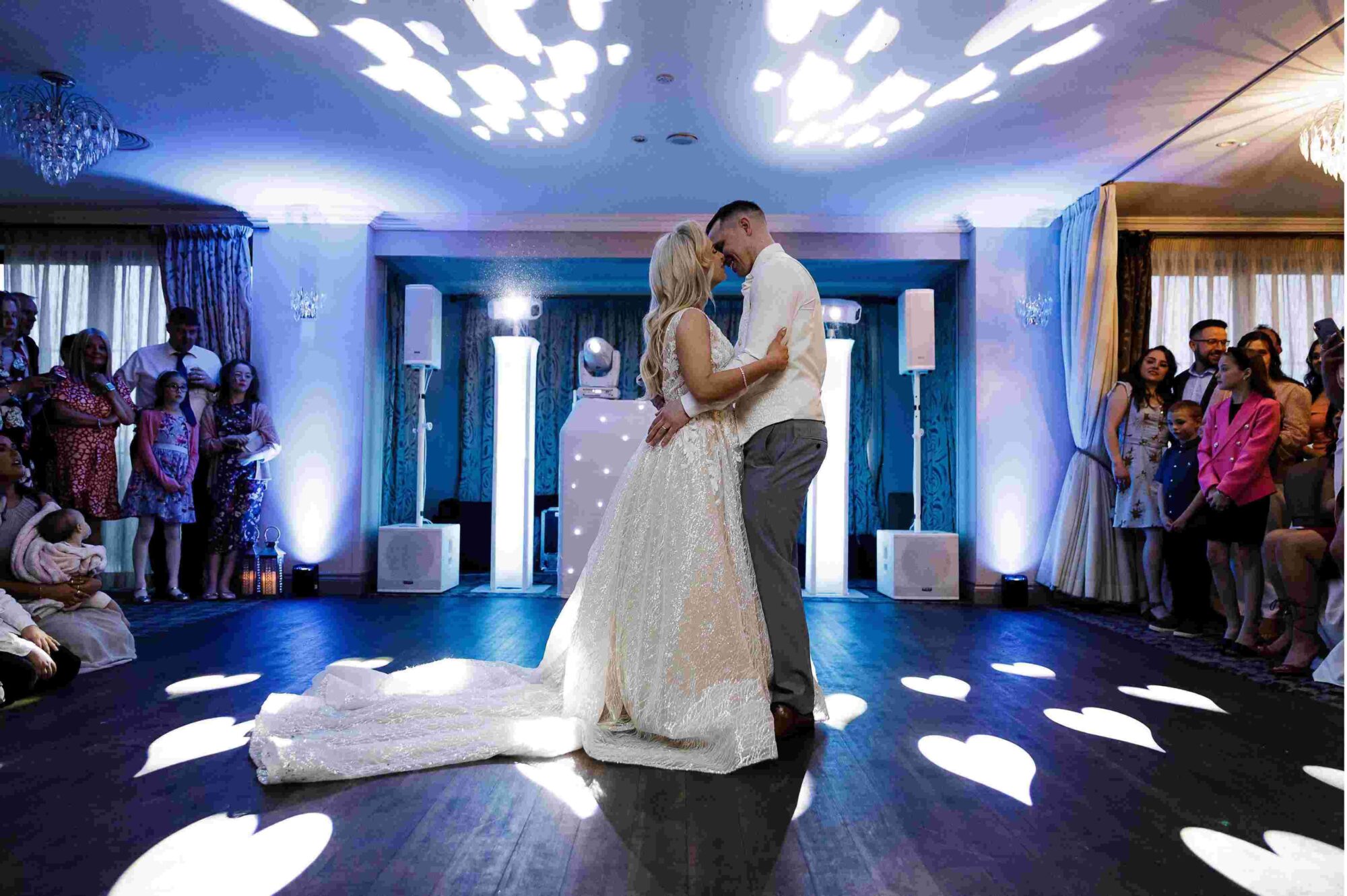 Couples first dance under blue lights