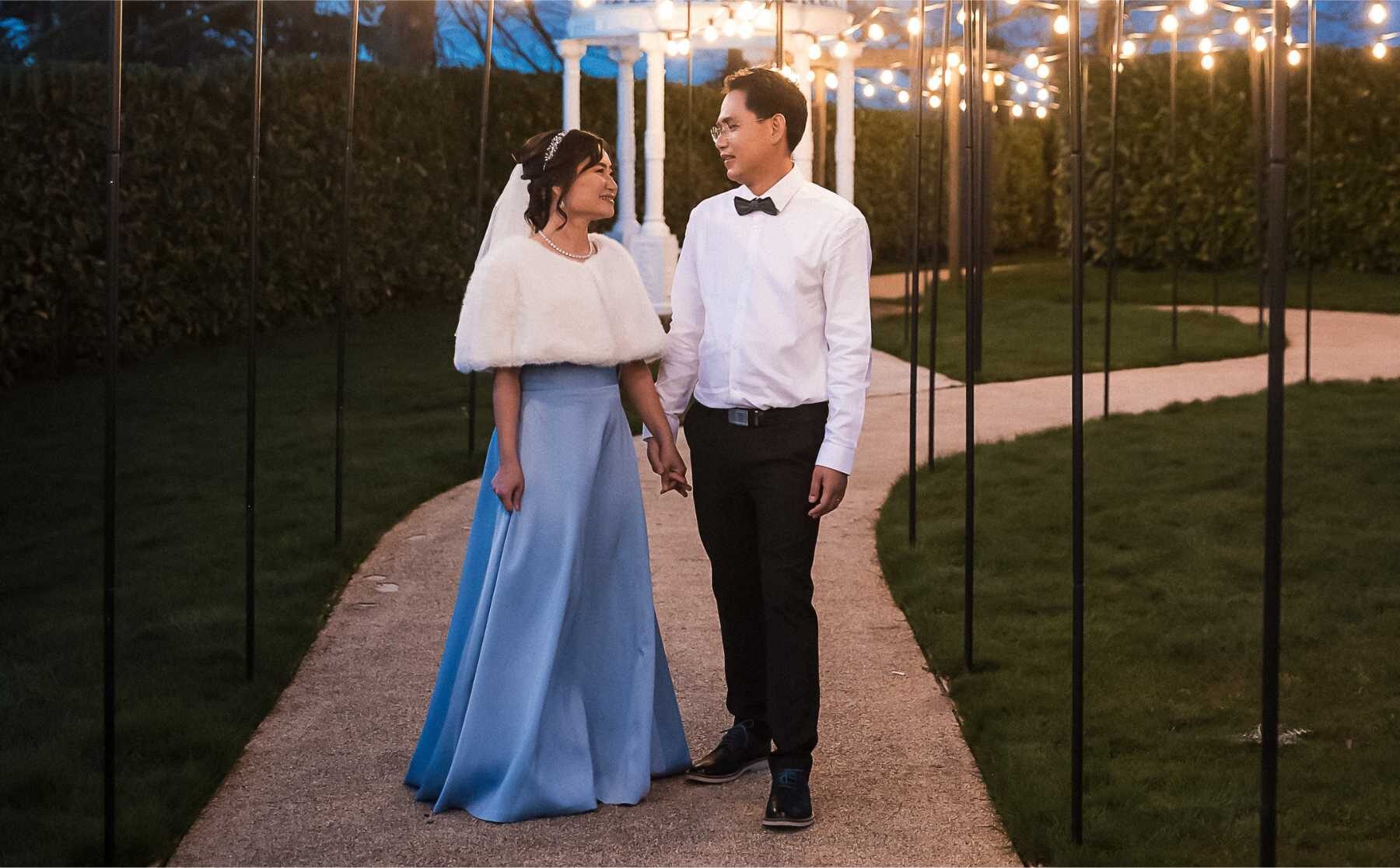 Wedding couple during the evening under twinkle lights